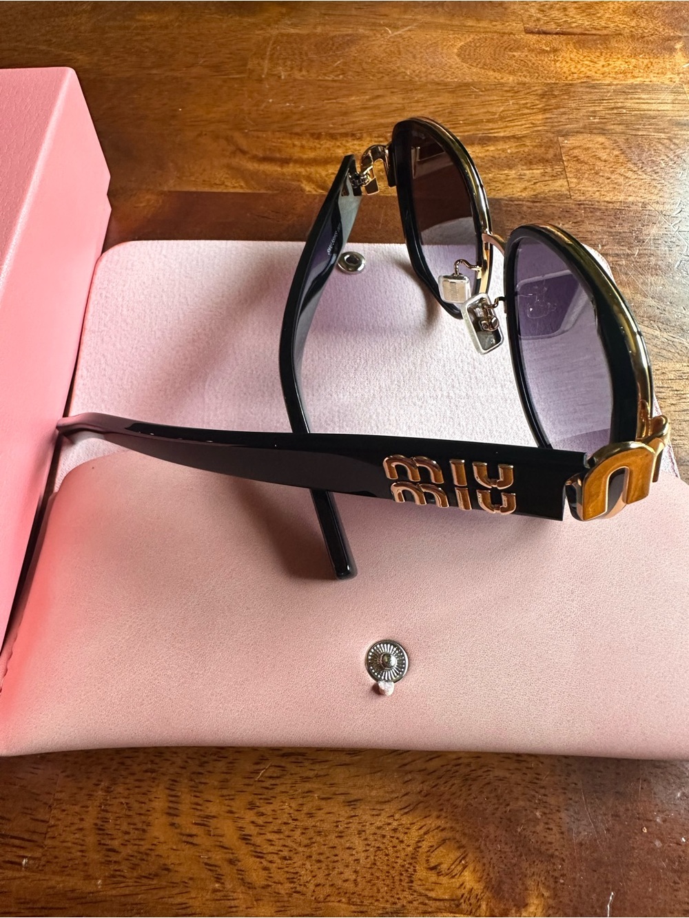 Miu Miu Black Sunglasses with Gold Logo Accent